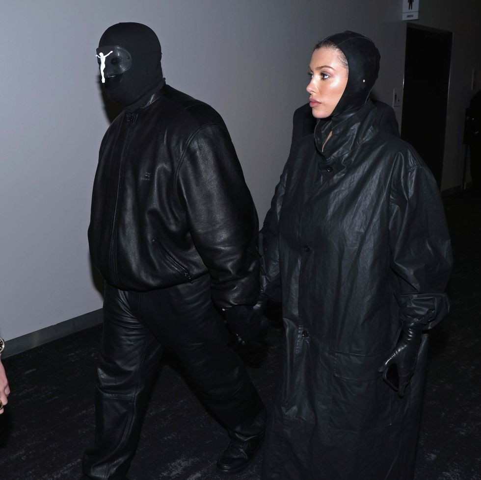 a man in a black leather jacket and a woman in a black dress
