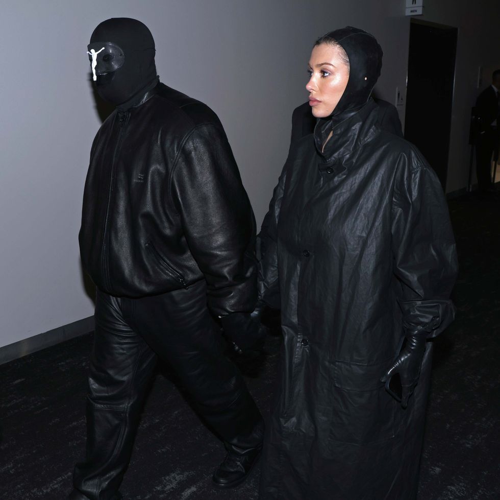 a man in a black leather jacket and a woman in a black dress