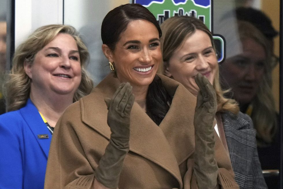 meghan, duchess of sussex, raises her hands after a first nations welcome during an invictus games wheelchair curling training camp in vancouver, british columbia, friday, feb 16, 2024 darryl dyckthe canadian press via ap