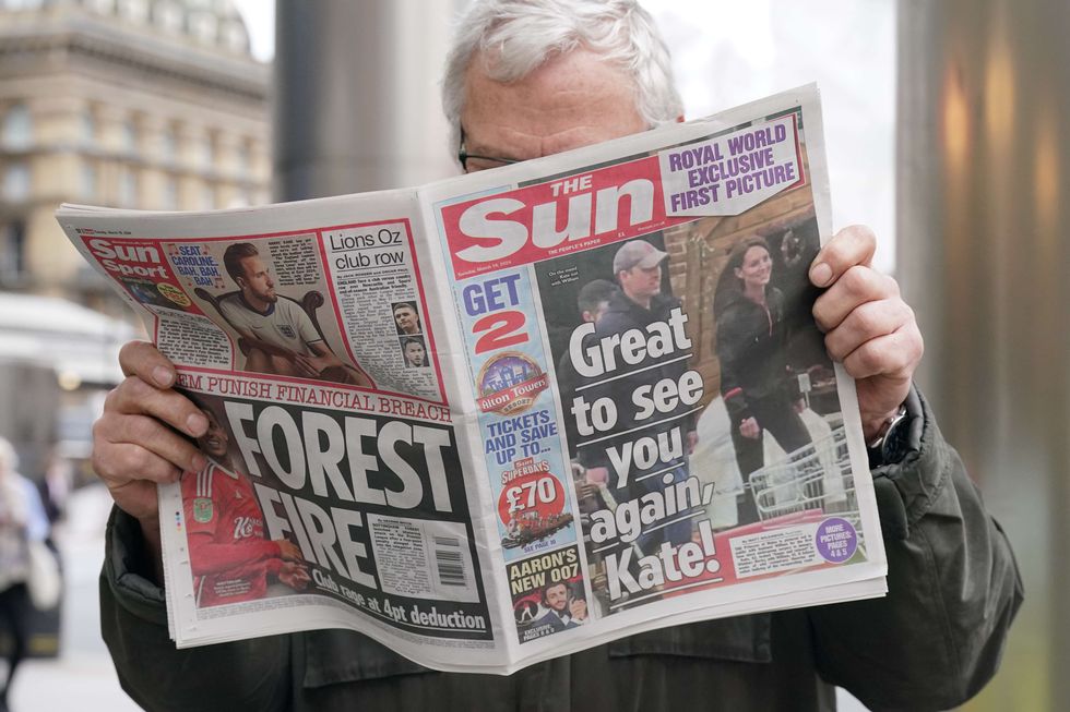 a person holding a newspaper