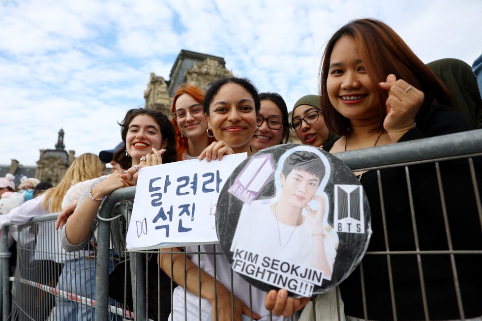 paris 2024 olympics olympic torch is welcomed in paris paris, france july 14, 2024 fans wait for singer and bts band member jin to arrive at the louvre museum with the olympic flame reutersstephanie lecocq