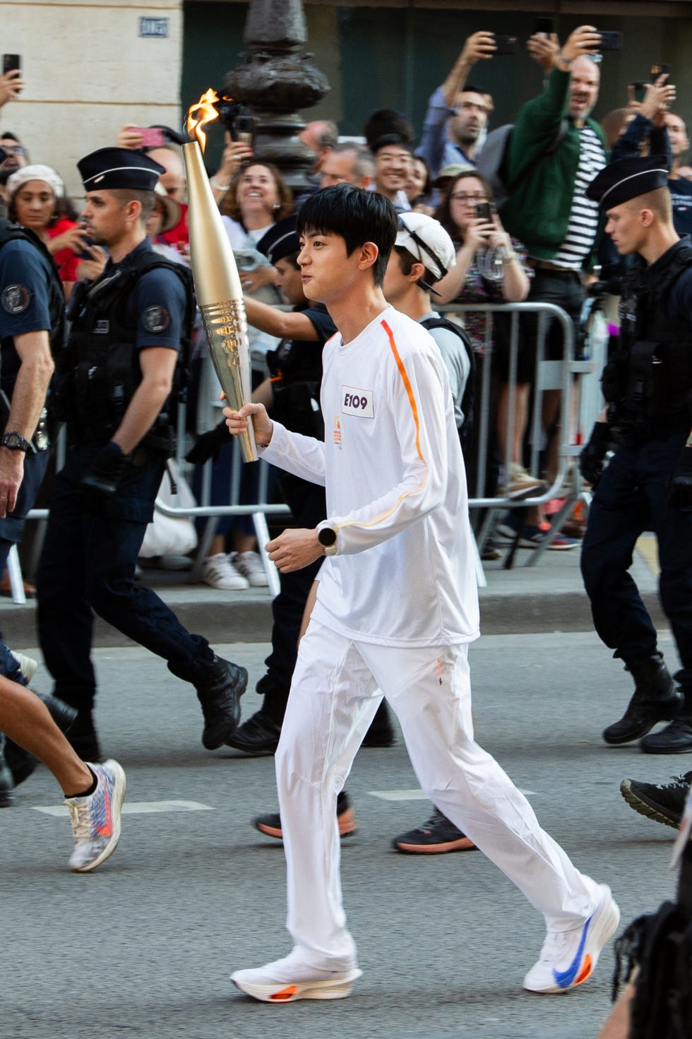 kim seok jin, a member of south korean band bts with the olympic torch travels at rivoli avenue as part of the torch relay for the paris olympic games on july 14, 2024 in paris, france photo by nasser berzaneabacapresscom