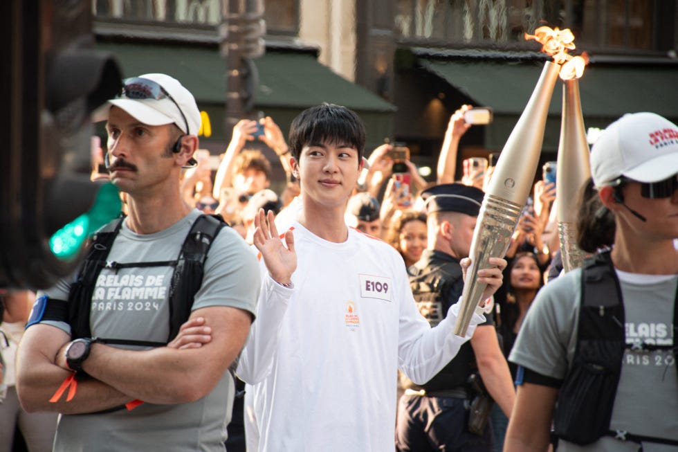 olympic torch flame kim seok jin, a member of south korean band bts on the rue de rivoli near louvre museum during the olympic torch relay in paris on july 14, 2024 photo by florian poitoutabacapresscom