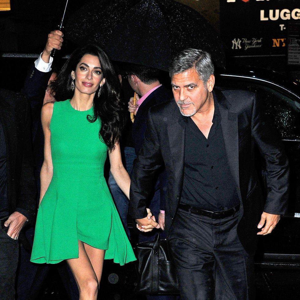 new york, ny   actor, george clooney, lovingly gazed at his beautiful wife, amal clooney, as they exited their limo during a rainy nyc night  amal clooney was seen in an emerald green dress, emerald green high heel sandals, and a gold clutchakm gsi          september 29, 2015to license these photos, please contact steve ginsburg310 505 8447323 423 9397steveakmgsicomsalesakmgsicomormaria buda917 242 1505mbudaakmgsicomginsburgspalyincgmailcom