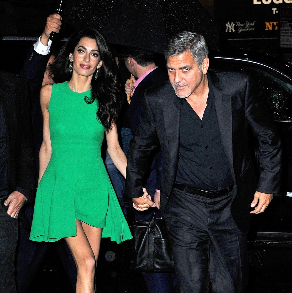 new york, ny   actor, george clooney, lovingly gazed at his beautiful wife, amal clooney, as they exited their limo during a rainy nyc night  amal clooney was seen in an emerald green dress, emerald green high heel sandals, and a gold clutchakm gsi          september 29, 2015to license these photos, please contact steve ginsburg310 505 8447323 423 9397steveakmgsicomsalesakmgsicomormaria buda917 242 1505mbudaakmgsicomginsburgspalyincgmailcom