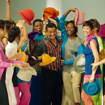 models in colorful clothes surround japanese designer issey miyake after the presentation of his 1994 spring summer ready to wear collection presented in paris, oct 8, 1993  ap photolionel cironneau
