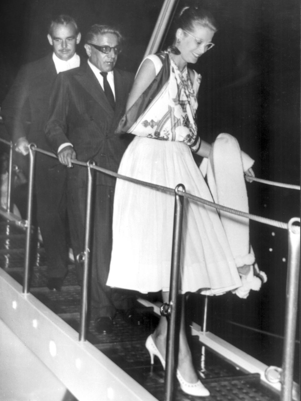 arisitotle onassis and prince rainier and princess grace kelly, aug 29, 1959  arisitotle onassis, prince rainier and princess grace kelly coming down the steps of the luxury yacht "christina" owned by onassis princess grace has her arm in sling due to a wasp sting whilst out at sea monte carlo   29th august 1959 photo by topfotoaflo 3619