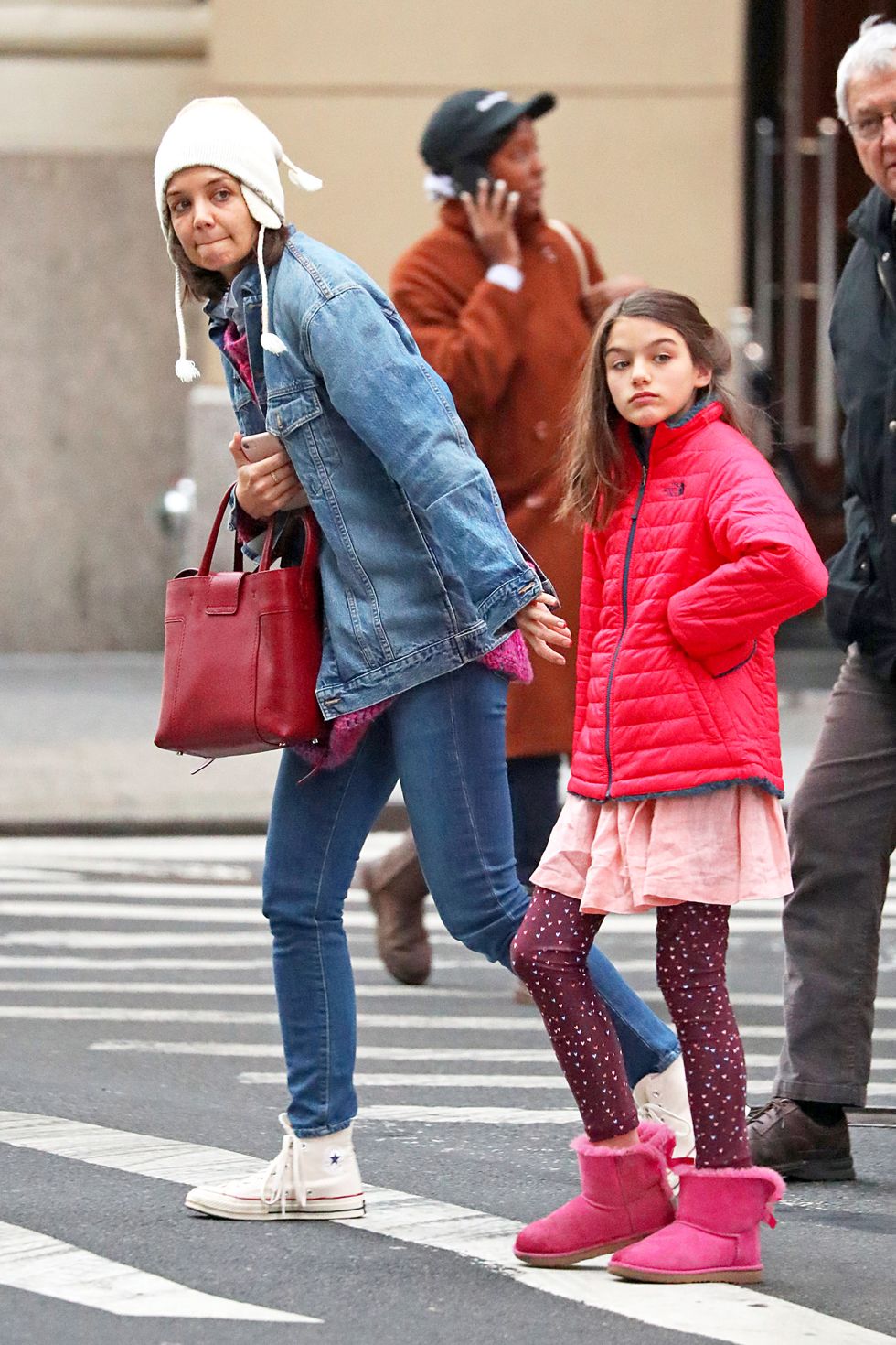 EXCLUSIVE: Katie Holmes Steps Out with Her Parents and Takes Suri Ice Skating in New York City.