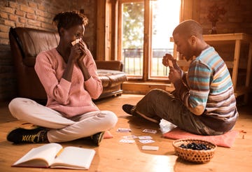 couple having fun while playing cards at home
