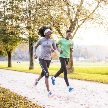 african american friends running Paris together in nature