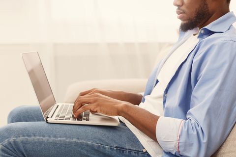 African-american man browsing work opportunities on laptop