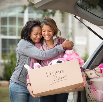 African American mother helping daughter pack for college african american mother helping daughter pack for college