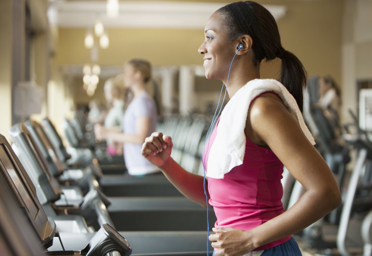 african american woman exercising on treadmill in gym