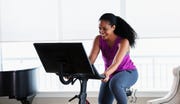 african american woman on exercise bike at home