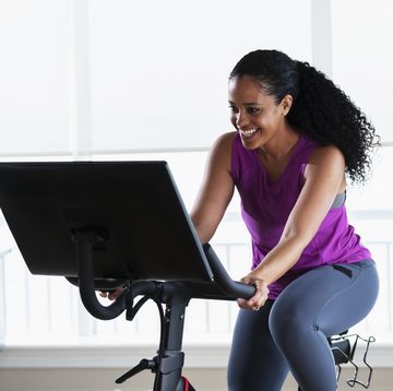 african american woman on exercise bike at home