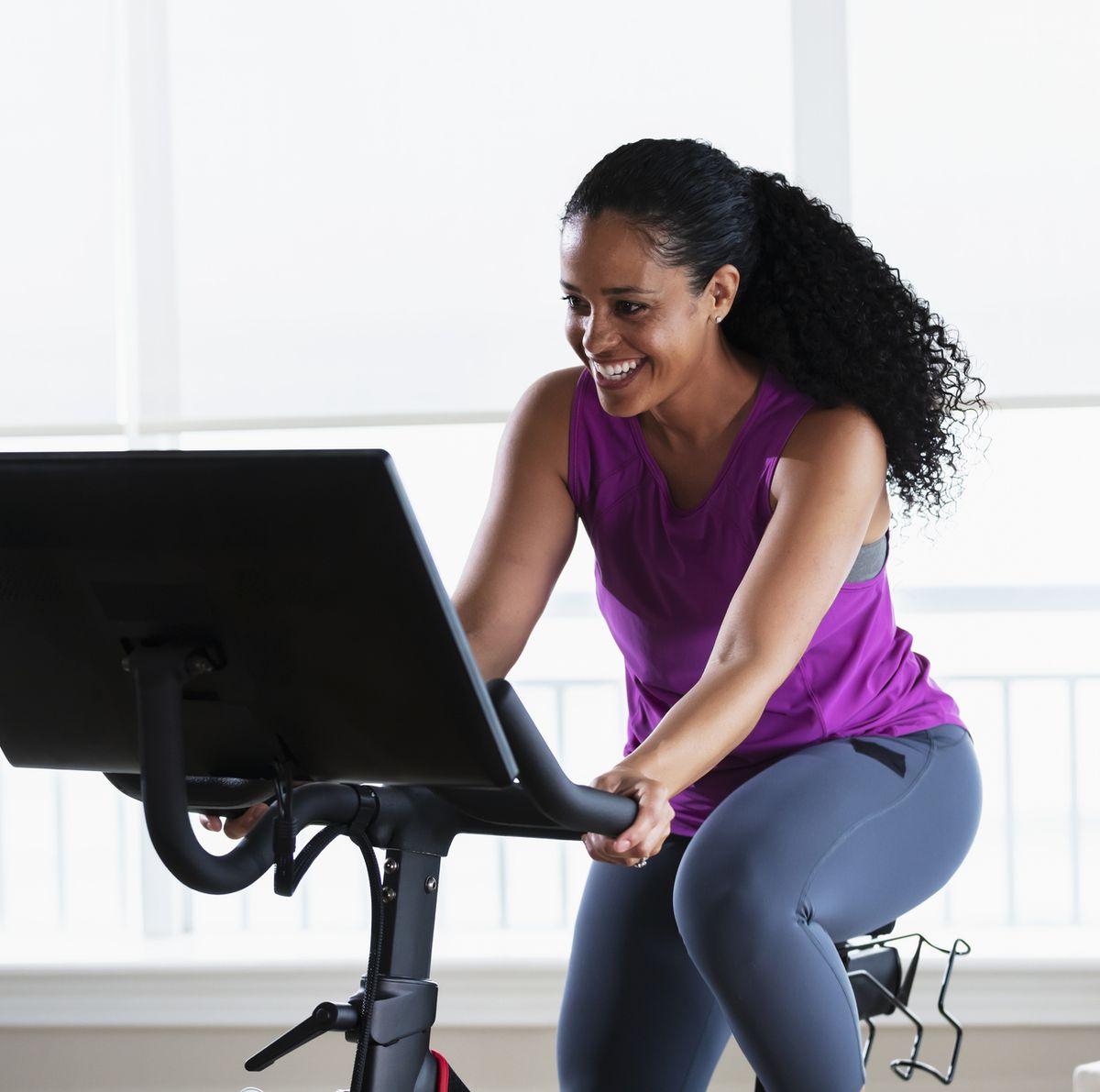 african american woman on exercise bike at home