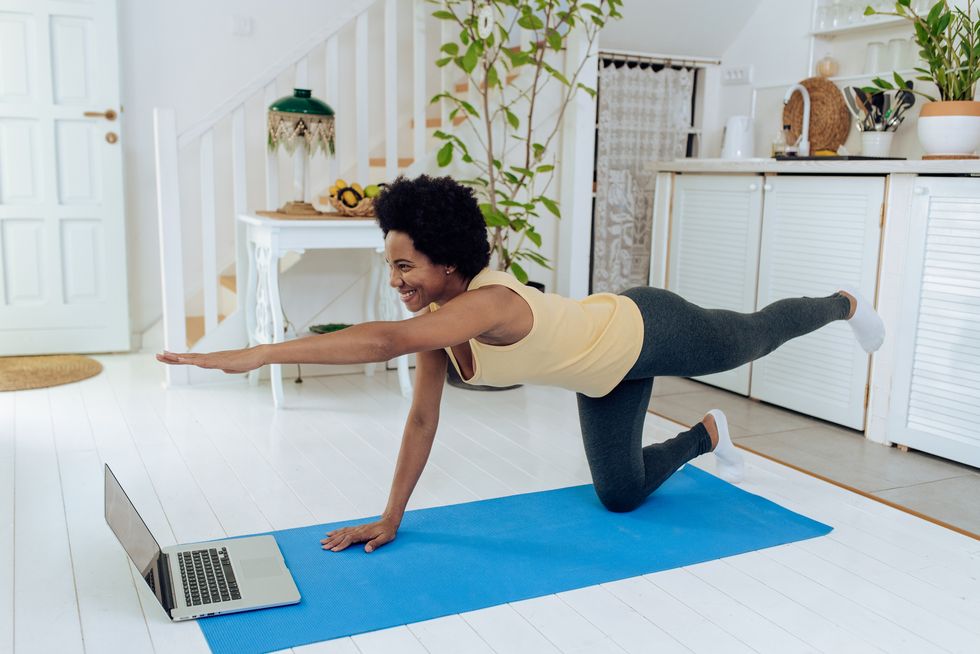 african american woman practicing pilates at home