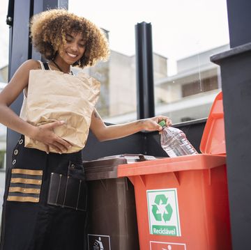 african american young woman recycling garbage sustainability concept