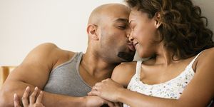 african couple kissing in bed