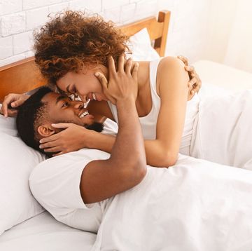 african couple of lovers relaxing in bed at home