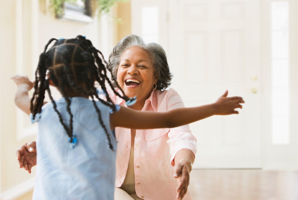 african grandmother and granddaughter running to hug each other