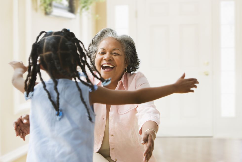 african grandmother and granddaughter running to hug each other