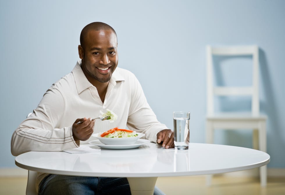 African man eating dinner