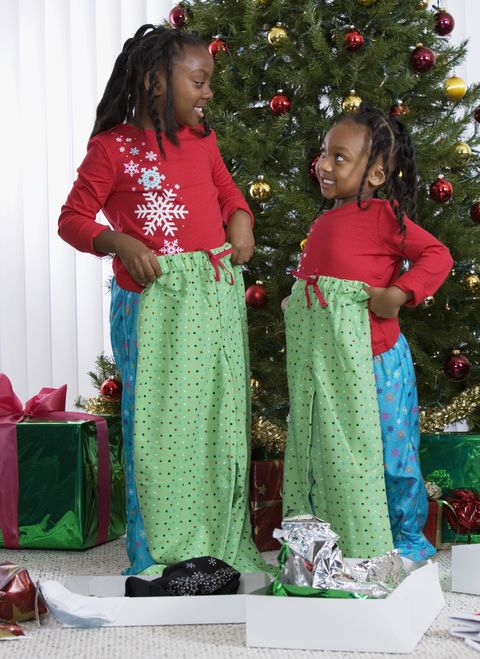 african sisters holding matching christmas gifts