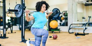 african woman practicing with barbells