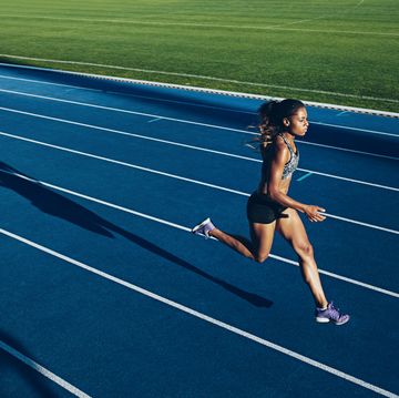 african woman running on racetrack