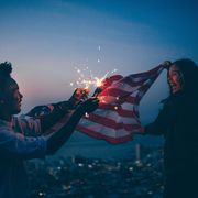 Afro amercian man and woman celebrating with USA flag and