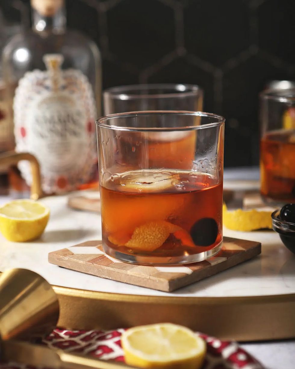 bourbon amaro cocktail with lemon slices