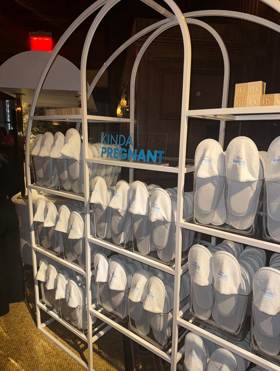 display of white slippers at the kinda pregnant premiere