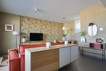 salón con sofá de color terracota y muebles de madera