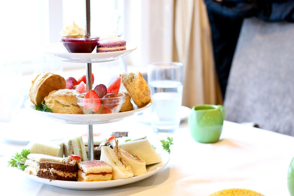afternoon tea three tier stand of desserts, fresh fruits, pastries and sandwiches