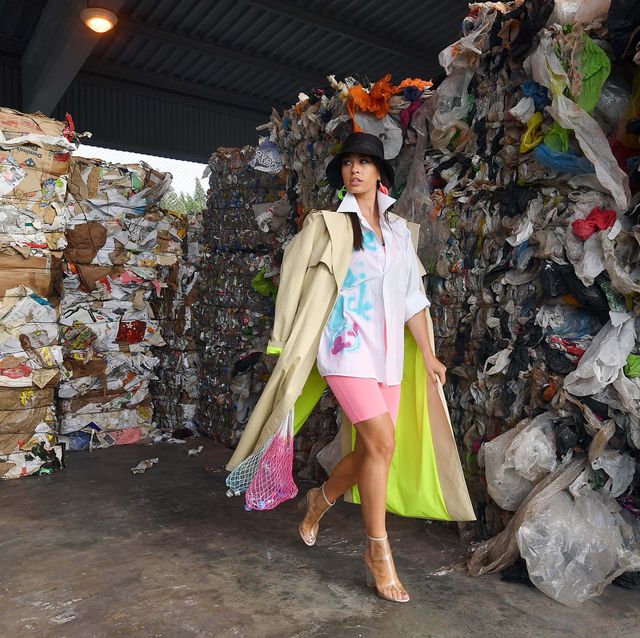 minsk, belarus  july 4, 2019 a model carries net shopping bags during a fashion show at a waste recycling plant near the trostenetsky dumping ground as part of a campaign under the slogan "goodbye plastic bag or make avoska great again" suggesting using avoska string bags instead of the plastic ones viktor drachevtass photo by viktor drachev\tass via getty images