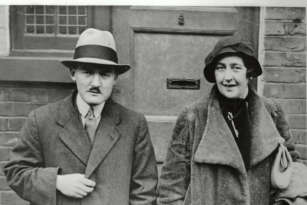 max mallowan and agatha christie stand next to each other and smile while looking ahead