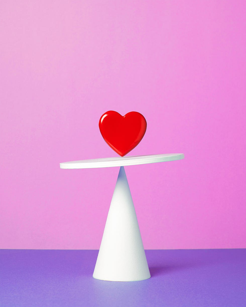 heart balancing on a white shape