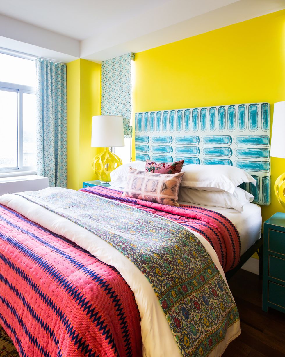 bedroom with yellow walls and pink bedding
