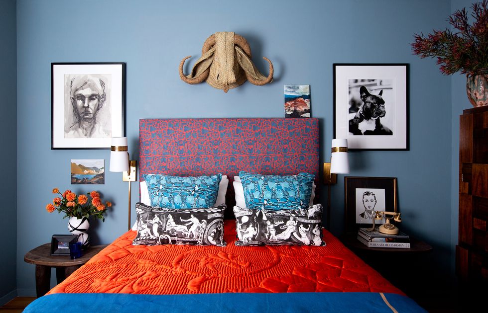 bedroom with blue walls and orange bedding