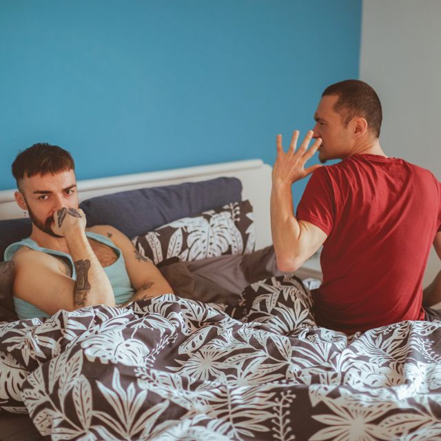agitated man arguing with his boyfriend in bedroom