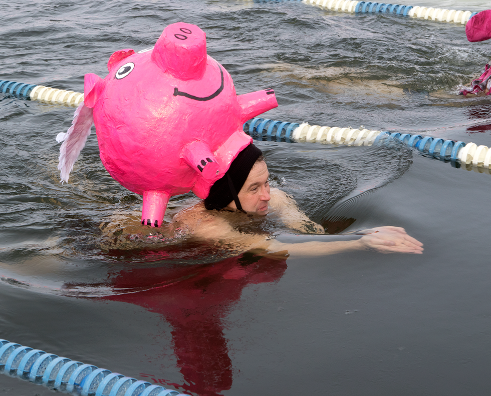 derek tucker struggles to make it down the lane under the weight of his enormous pig hat