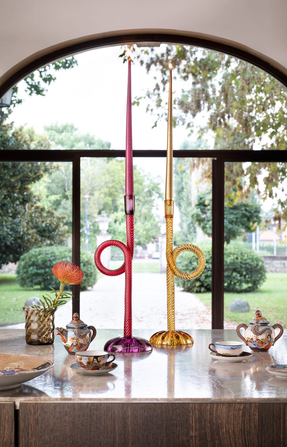 a table set with glass candlesticks