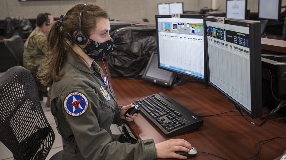 rebecca mitchell, t 7a lead flight test engineer, 416th flight test squadron, watches real time flight telemetry of a remote t 7a red hawk test flight from the boeing flight test center in st louis, missouri, at the ridley mission control center on edwards air force base, california, april 30 air force photo by giancarlo casem