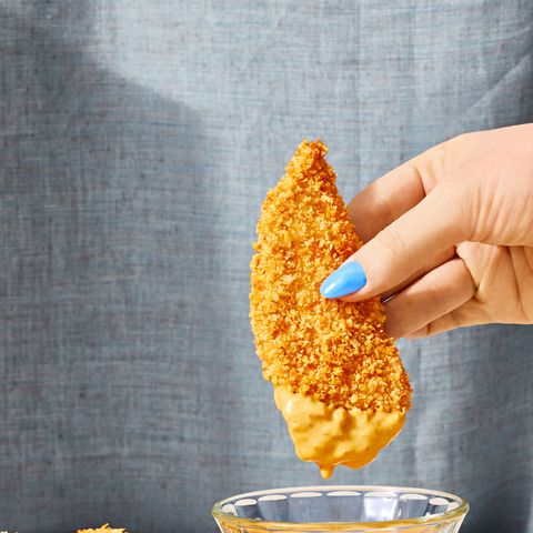 breaded chicken strips dipped in yellow sauce