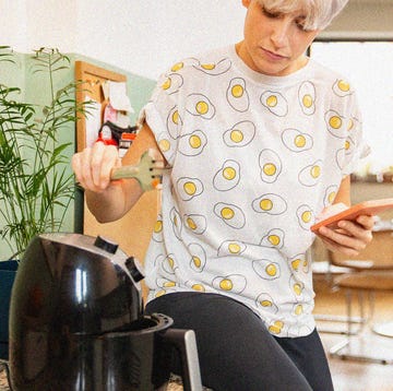 person cooking with air fryer