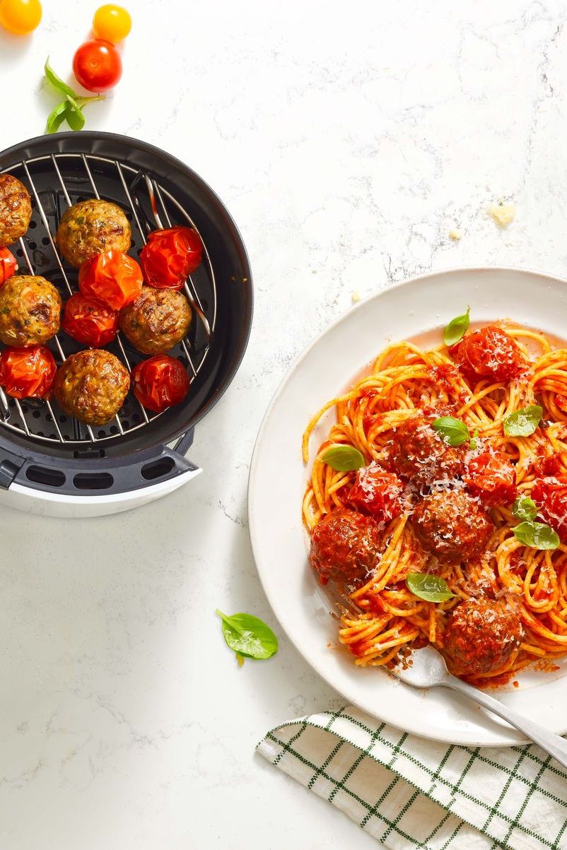 spaghetti and air fryer meatballs on a white marble surface