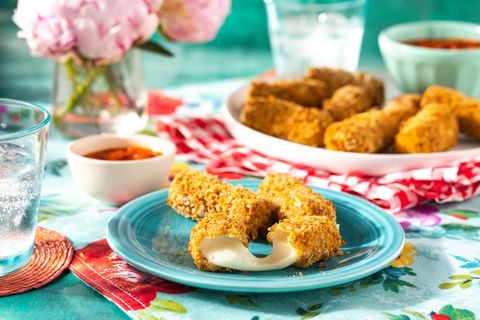air fryer recipes air fryer mozzarella sticks on blue plate with cheese oozing