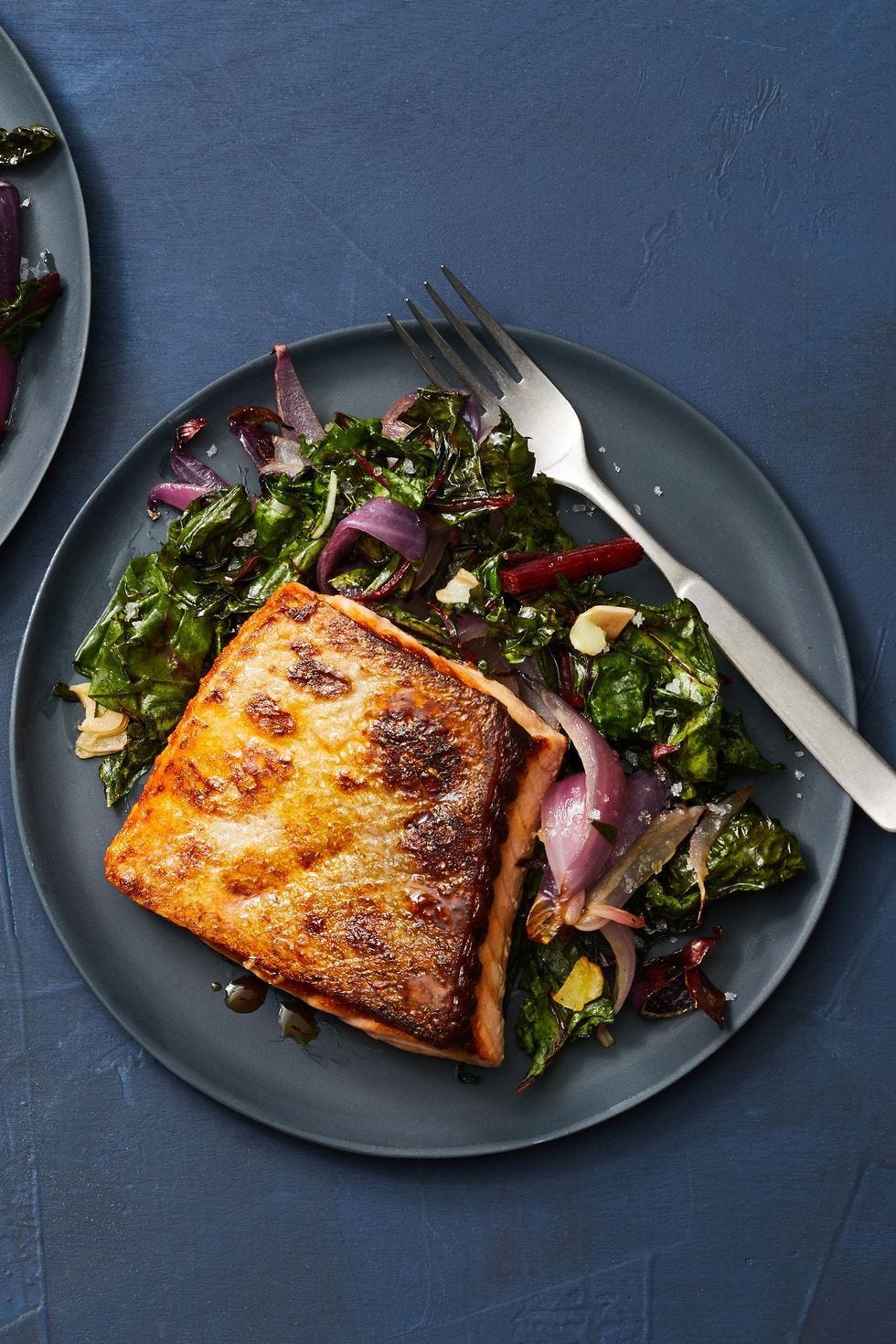 a plate of food with air fryer salmon and swiss chard and a fork