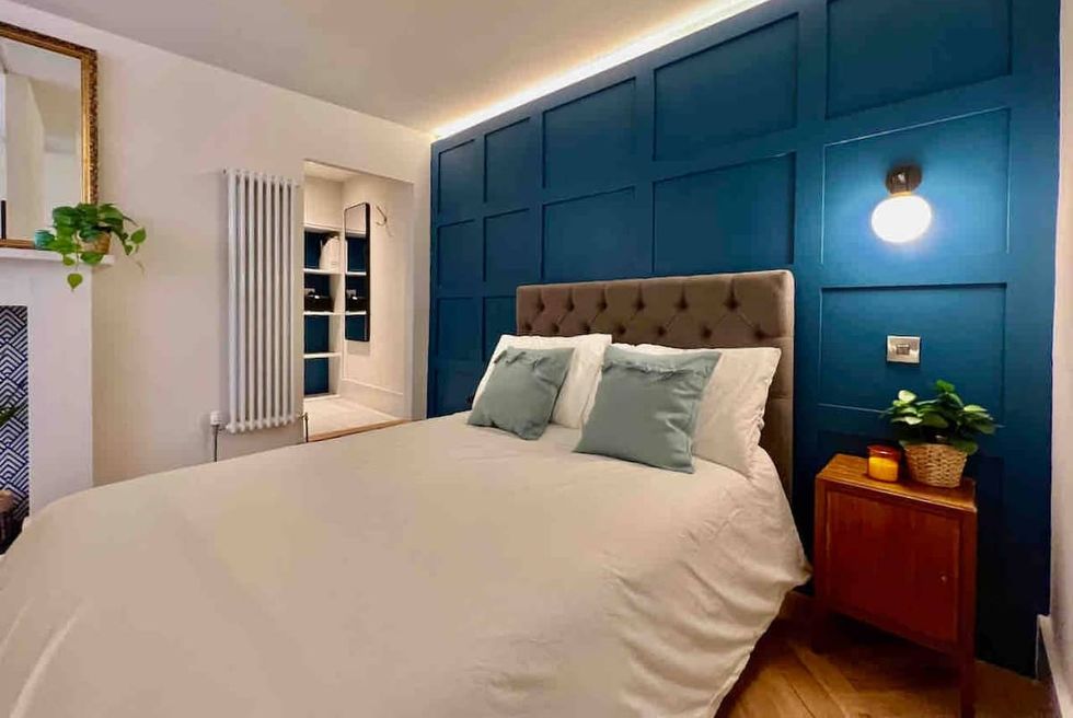 a bedroom with a bed and blue walls
